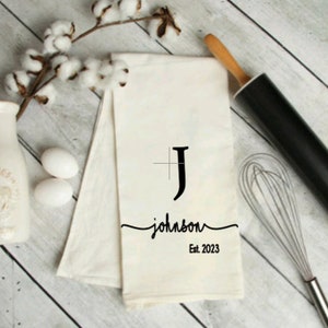 May include: White kitchen towel with a black monogram "J" and the text "johnson Est. 2023".