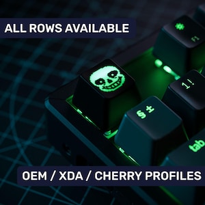 May include: A black mechanical keyboard with green backlighting. The keyboard has a keycap with a pixelated skull design. The text "ALL ROWS AVAILABLE" and "OEM/XDA/CHERRY PROFILES" is visible on the image.