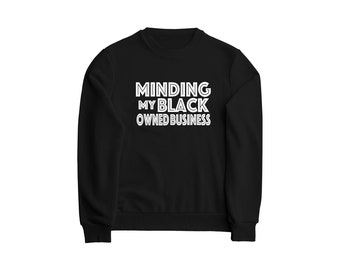 May include: Black sweatshirt with white text that reads "Minding My Black Owned Business".