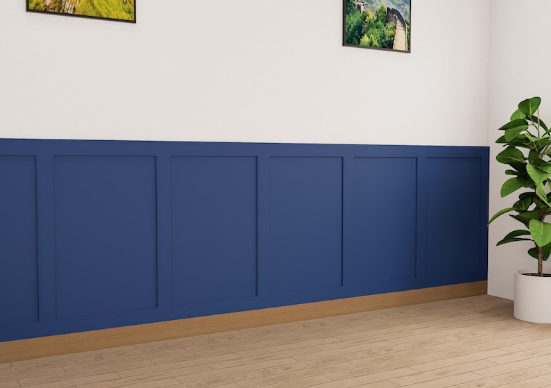 May include: A white wall with a blue wainscot paneling. The wainscot is made up of six panels with a wood trim around each panel. The wall is painted white above the wainscot and the wainscot is painted a dark blue. There is a plant in a white pot in the corner of the room.