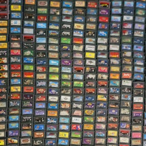 May include: A large collection of colorful Game Boy Advance game cartridges. The cartridges are arranged in rows and columns, and they feature a variety of different game titles.