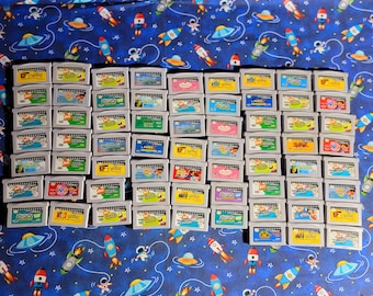 May include: A collection of 48 Game Boy Advance game cartridges, featuring a variety of titles from the "Nickelodeon" brand. The cartridges are arranged in rows and columns, with a blue and white patterned background.