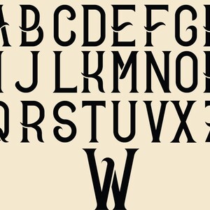 May include: Black and white alphabet font with decorative flourishes. The letters are in a bold, serif style. The font is uppercase and includes all 26 letters of the alphabet.