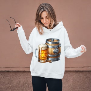 May include: White hoodie with a graphic of a beer mug and a wooden barrel. The barrel has metal bands and a tap.
