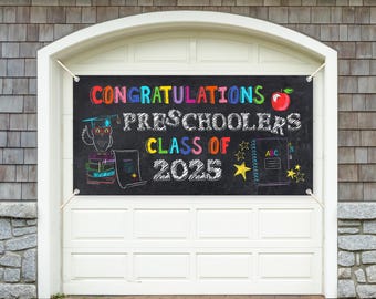 May include: Black and white chalkboard banner with the text "Congratulations Preschoolers Class of 2025". The banner has colorful illustrations of a graduation cap, an owl, books, a star, and a notebook with the letters "ABC" on it. There is also a red apple with a leaf.