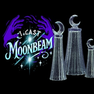 May include: Three clear glass bottle stoppers with a crescent moon design on top. The stoppers are different sizes and are set against a black background. The image also includes the text "I CAST MOONBEAM" with a purple and teal color scheme.