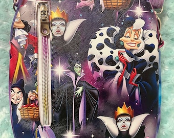 May include: A purple and black crossbody bag with a zipper closure. The bag features a repeating pattern of Disney villains including Cruella de Vil, Maleficent, and the Evil Queen.
