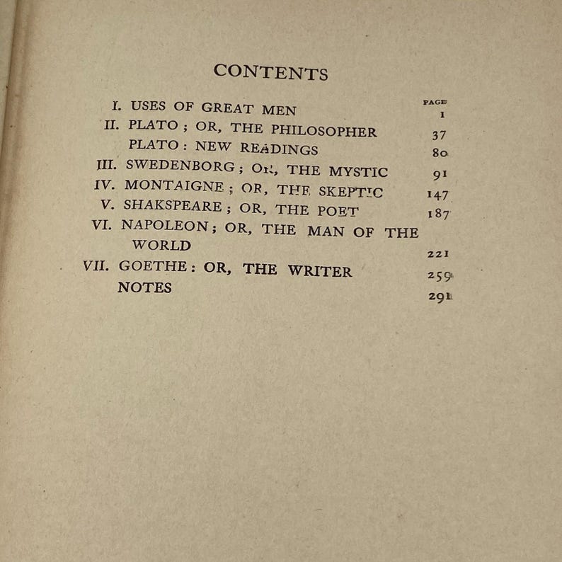 May include: A page from a book with the title "CONTENTS" at the top. The text lists chapter titles such as "USES OF GREAT MEN" and "PLATO", along with corresponding page numbers. The text is in black font.