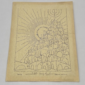 May include: An aged paper print featuring a detailed illustration of a city, possibly Jerusalem, constructed from intricate text. The artwork includes a sunburst design and Hebrew text, with signatures at the bottom. The overall color is a warm, sepia tone.
