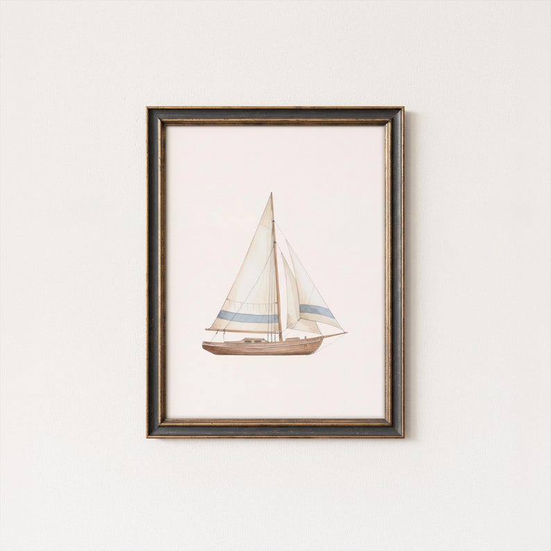 May include: Watercolor painting of a sailboat in a black and gold frame. The boat has a brown hull, white sails with blue stripes, and a light pink background. A nautical themed art print.