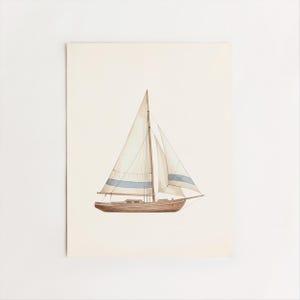 May include: Watercolor painting of a sailboat with a brown hull, white sails, and a blue stripe. The artwork is on a cream-colored background, evoking a nautical theme. The boat is depicted with detailed rigging and sails.