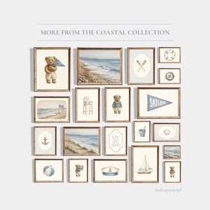 May include: A collection of framed art prints with a coastal theme. The prints feature watercolor illustrations of teddy bears, beach scenes, nautical elements, and the text "SAILOR". The color palette includes blues, tans, and browns.