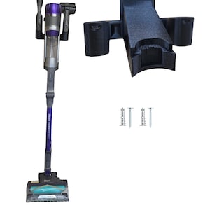 May include: A cordless Shark POWERFLECT vacuum cleaner with a black and purple design, a black wall mount, and two screws. The vacuum has a clear dustbin and a motorized brush head.
