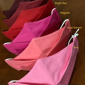 May include: Five face masks in various shades of red and pink, from darkest to lightest: Merlot, Burgundy, Bright Red, Magenta, Coral Salmon, and Pink.