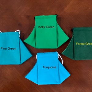 May include: Four fabric face masks in different shades of green and turquoise. The masks are labeled "Kelly Green", "Forest Green", "Pine Green", and "Turquoise".