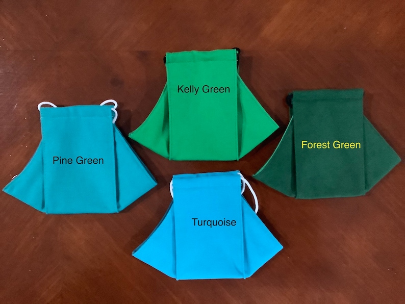 May include: Four fabric face masks in different shades of green and turquoise. The masks are labeled "Kelly Green", "Forest Green", "Pine Green", and "Turquoise".