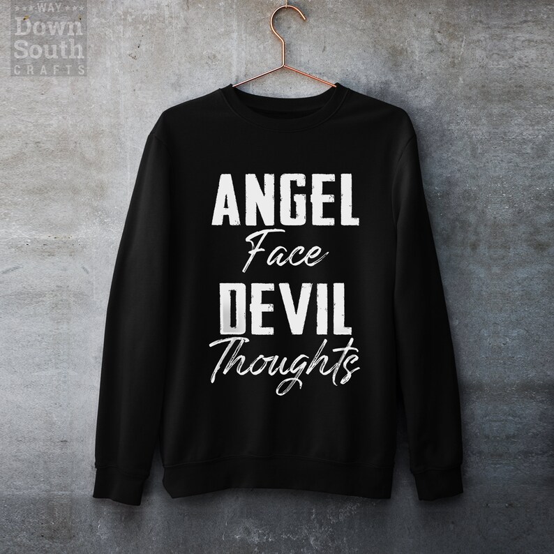 May include: Black sweatshirt with white text that reads "Angel Face Devil Thoughts".