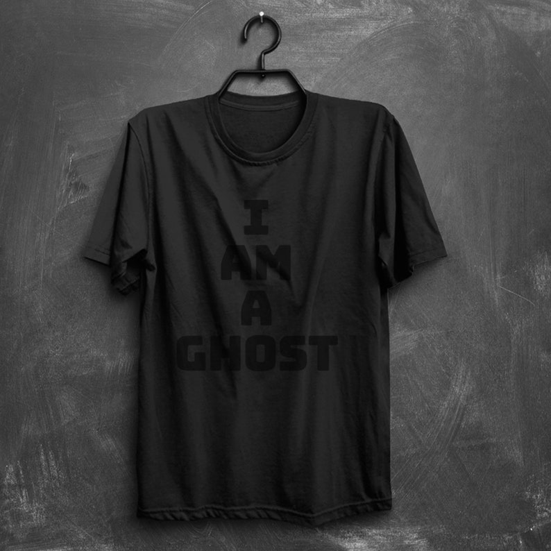 May include: Black t-shirt with the text "I AM A GHOST" printed on the front in white.