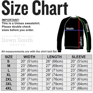 May include: Size chart for a unisex sweatshirt with measurements in inches and centimeters. The chart shows the width, length, and sleeve length for sizes S through 4XL.