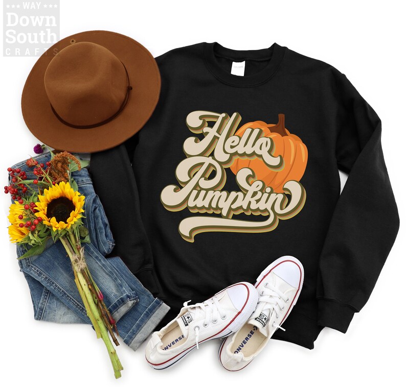 May include: Black sweatshirt with a graphic of a pumpkin and the text "Hello Pumpkin" in a retro font.