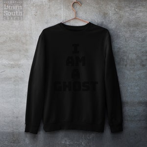 May include: Black sweatshirt with the text "I AM A GHOST" printed in white.