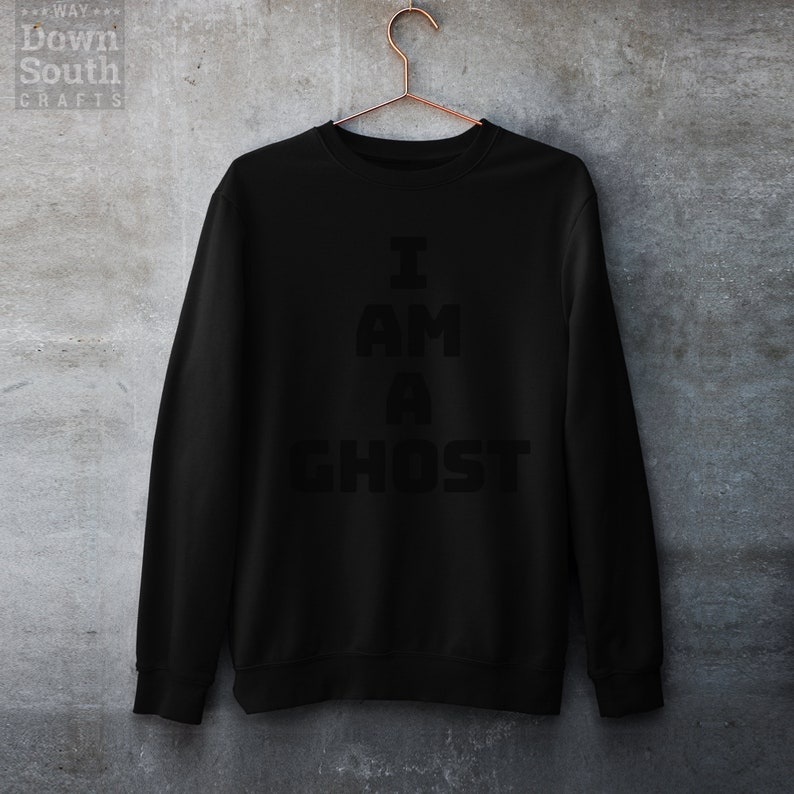 May include: Black sweatshirt with the text "I AM A GHOST" printed in white.