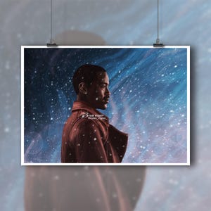 May include: A framed art print depicting a profile portrait of a person in a red coat set against a blue and white starry backdrop. The artist's signature and social media handle are visible in the lower left corner.