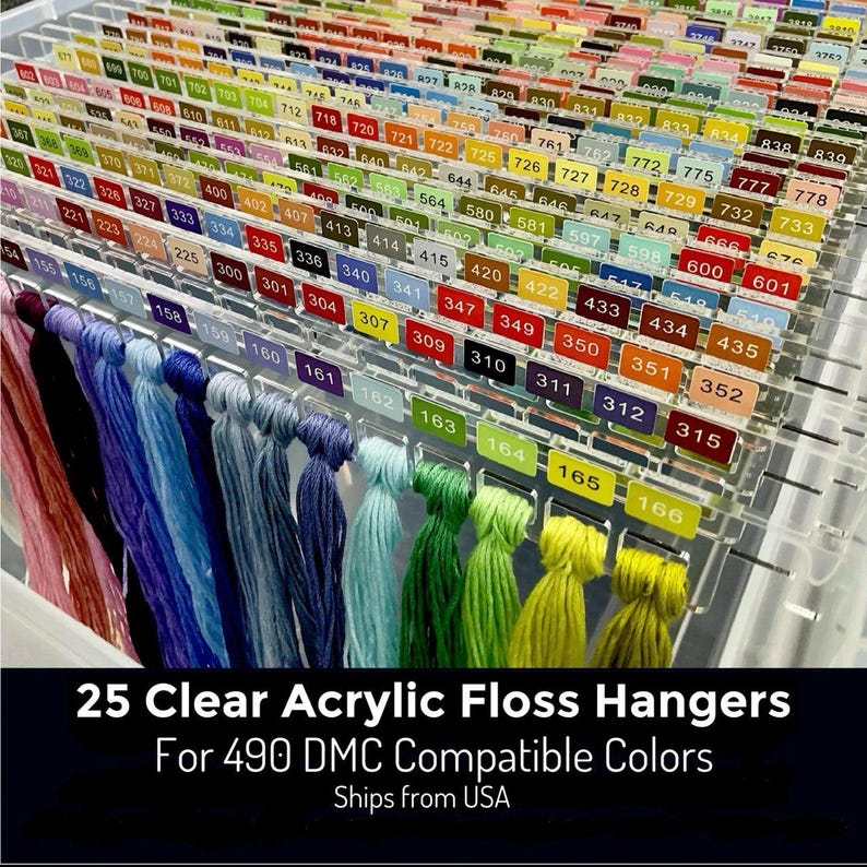 May include: Clear acrylic floss hangers with colour-coded labels, holding a variety of embroidery floss in shades of pink, blue, green, and yellow. The image includes the text "25 Clear Acrylic Floss Hangers For 490 DMC Compatible Colors."