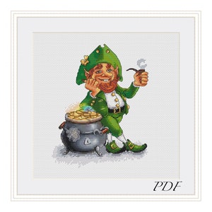 May include: A green leprechaun with a red beard and a green hat sits beside a pot of gold. He is holding a pipe in his right hand and is smiling. The image is a cross stitch pattern.