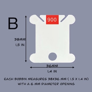 May include: White plastic bobbin with a 6 mm diameter opening. The bobbin measures 1.5 inches by 1.4 inches. The number 900 is printed on the bobbin.