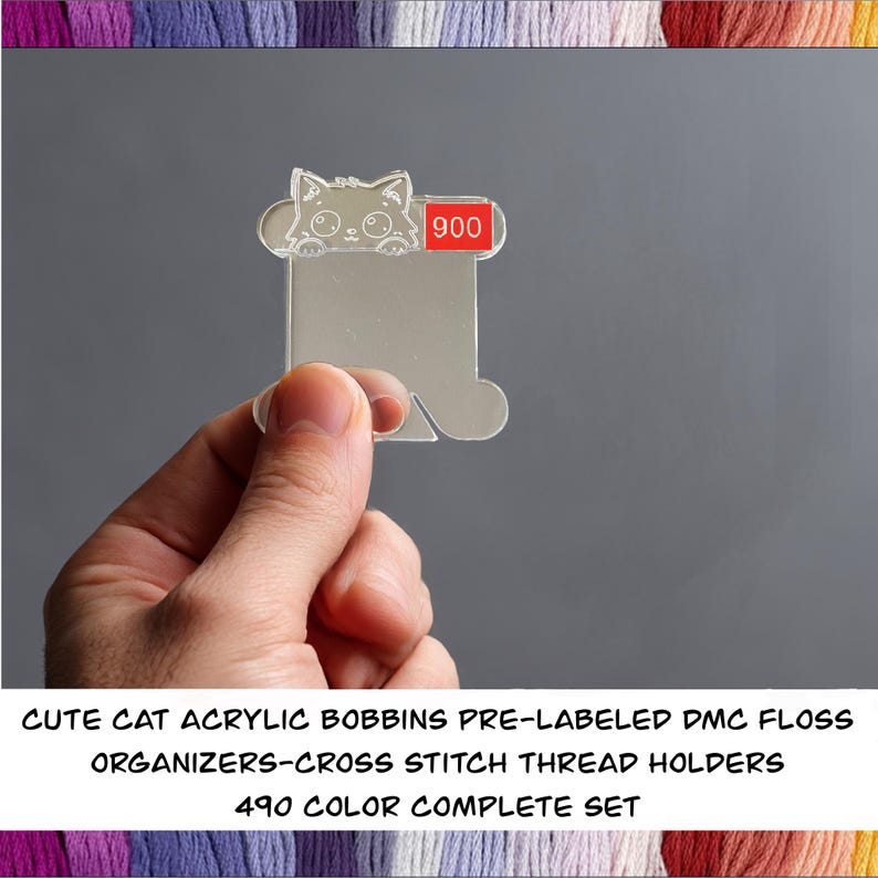 May include: Clear acrylic bobbin with a cat design and the number 900 in a red box. The bobbin is designed for organizing cross-stitch thread. Text at the bottom reads: "CUTE CAT ACRYLIC BOBBINS PRE-LABELED DMC FLOSS ORGANIZERS-CROSS STITCH THREAD HOLDERS 490 COLOR COMPLETE SET."