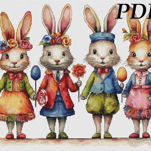 Puede incluir: Cuatro conejos de Pascua vestidos con atuendos coloridos y sosteniendo dulces. Los conejos están de pie en fila, y cada uno tiene una expresión diferente en su rostro. El conejo de la izquierda lleva una chaqueta verde y una falda amarilla, el conejo del medio lleva una chaqueta roja y una falda azul, el conejo de la derecha lleva una chaqueta azul y pantalones verdes, y el conejo de la derecha lleva un vestido rosa.