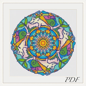 May include: A colorful cross-stitch pattern featuring a mandala design with a central flower and surrounding white animals. The pattern is surrounded by a border of green leaves and swirls.