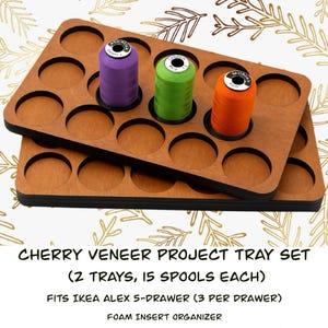 May include: Cherry veneer project tray set with two trays, each holding 15 spools. The trays have circular cutouts for spools and are designed to fit IKEA ALEX 5-drawer units. The image shows purple, green, and orange spools.