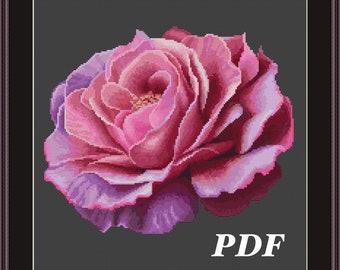 May include: A cross stitch pattern featuring a single pink rose with a purple hue on a dark gray background. The pattern is labeled "PDF".