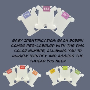 May include: White plastic bobbins with pre-labeled DMC thread colors. The bobbins are stacked in a pyramid shape with the numbers 3765, 552, 553, 919, 900, 722, 444, 907, and 910 visible. The text "EASY IDENTIFICATION: EACH BOBBIN COMES PRE-LABELED WITH THE DMC COLOR NUMBER, ALLOWING YOU TO QUICKLY IDENTIFY AND ACCESS THE THREAD YOU NEED" is printed below the bobbins.