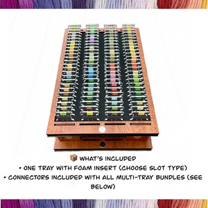 May include: A wooden craft organizer with multiple slots, each labeled with numbers. The organizer has a foam insert and includes connectors for multi-tray bundles. The text "WHAT'S INCLUDED" is visible, along with details about the tray and connectors.