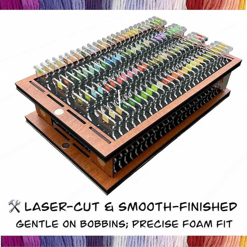 May include: A wooden thread organizer with multiple slots, holding numerous bobbins with colored thread. The organizer has a laser-cut design and smooth finish. The text at the bottom reads "LASER-CUT & SMOOTH-FINISHED GENTLE ON BOBBINS; PRECISE FOAM FIT."