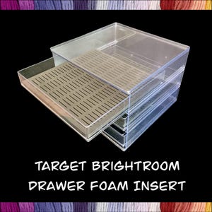 May include: Clear plastic storage drawer with a removable tan foam insert. The drawer is partially open, revealing the interior. The text "TARGET BRIGHTROOM DRAWER FOAM INSERT" is printed in white.