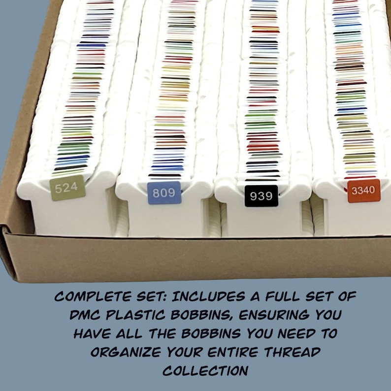 May include: A full set of DMC plastic bobbins for organizing embroidery floss. The bobbins are arranged in a box and labeled with numbers: 524, 809, 939, and 3340.