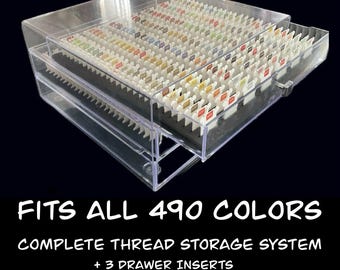 May include: Clear plastic thread storage system with three drawers, filled with spools of colorful thread. The text "FITS ALL 490 COLORS" is displayed at the bottom, along with "COMPLETE THREAD STORAGE SYSTEM + 3 DRAWER INSERTS 504 CAPACITY".