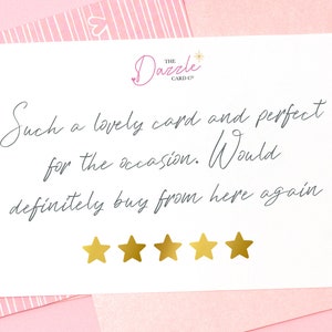 以下が含まれることがあります： 白いカードに手書きのレビューが書かれており、「Such a lovely card and perfect for the occasion. Would definitely buy from here again.」と書いてあります。レビューの下には金色の星が5つあります。カードはThe Dazzle Card Co.からです。