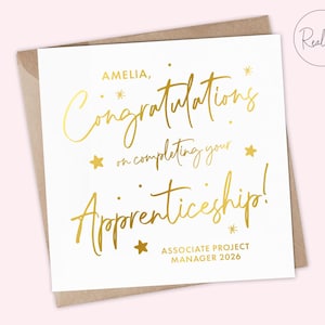May include: A white card with gold foil text, including "AMELIA, Congratulations on completing your Apprenticeship!" and "ASSOCIATE PROJECT MANAGER 2026". The card is presented in a brown envelope, with a "Real foil" stamp.