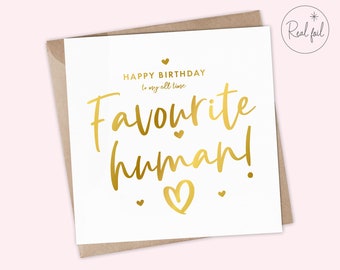 May include: A white card with gold foil lettering that reads "HAPPY BIRTHDAY to my all time Favourite human!" with a gold heart at the bottom.