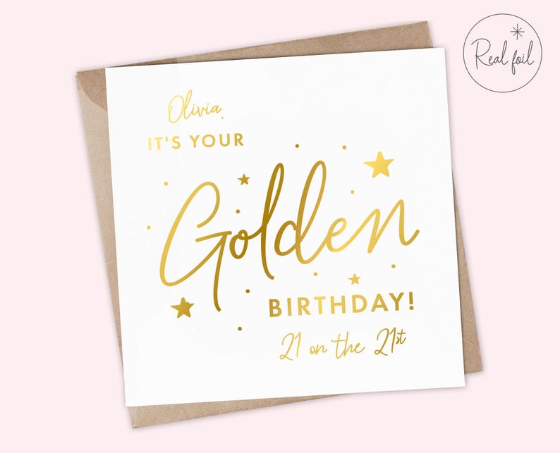 May include: A white card with gold foil lettering that says "Olivia, it's your Golden Birthday! 21 on the 21st".