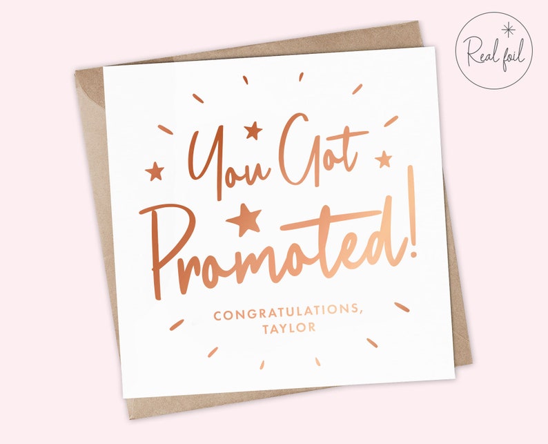 May include: A white card with a rose gold foil design that says "You Got Promoted!" with the text "Congratulations, Taylor" below.