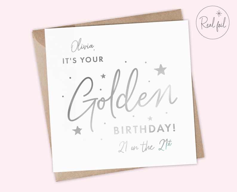 May include: A white card with silver foil lettering that says "Olivia, It's your Golden Birthday! 21 on the 21st".