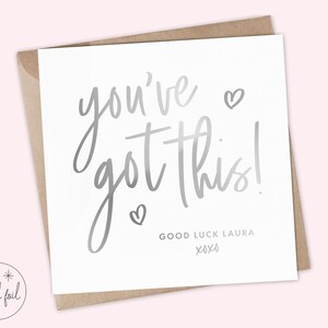 Op de afbeelding: Een witte kaart met zilveren folielettering die "you've got this!" zegt met twee kleine hartjes. De kaart bevat ook de tekst "Good Luck Laura xoxo".