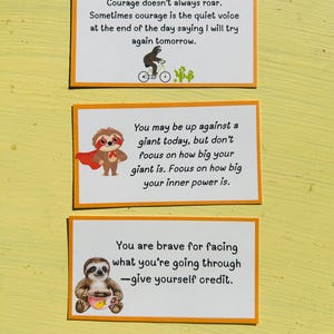 May include: Three rectangular cards with orange borders and white backgrounds. Each card features a different motivational quote with illustrations of sloths. The top card has a sloth riding a bicycle. The middle card has a sloth wearing a cape. The bottom card has a sloth holding a cup.