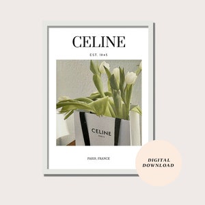 May include: A white shopping bag with black handles and the text "CELINE PARIS" printed on the front. White tulips are arranged inside the bag. The text "CELINE EST. 1945 PARIS, FRANCE" is printed below the image. The text "DIGITAL DOWNLOAD" is printed in a circle on the right side of the image.